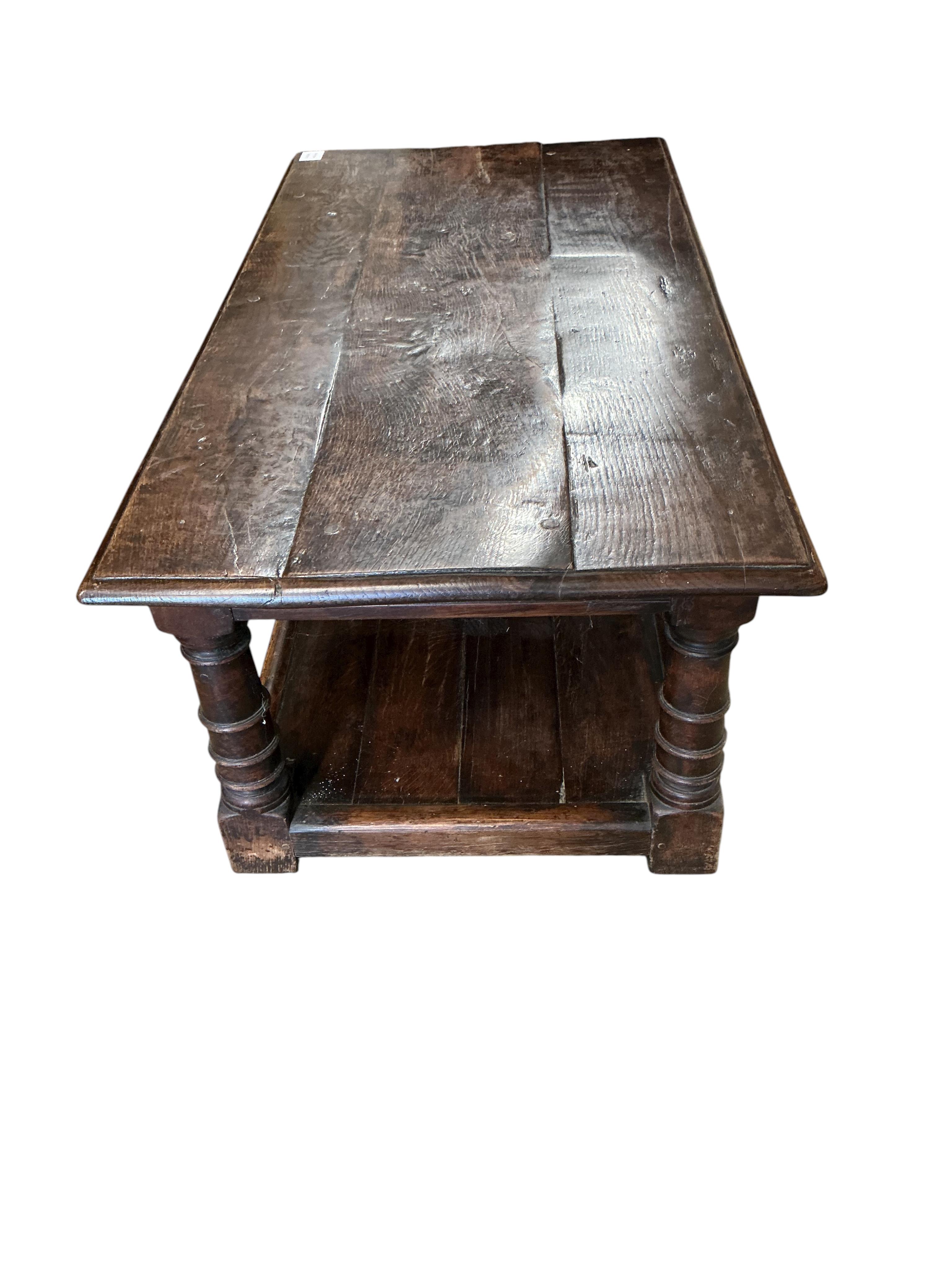A 17th century style rectangular oak two tier coffee table, width 106c, depth 55cm, height 43cm